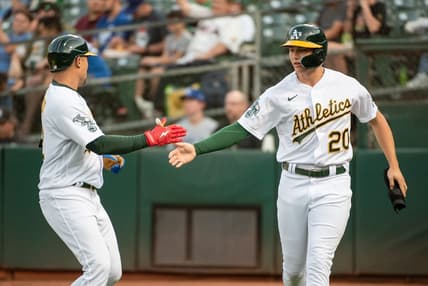 Aug 22, 2023; Oakland, California, USA; Oakland Athletics second baseman Zack Gelof (20) celebrates with shortstop Aledmys Diaz (12) after scoring during the first inning against the Kansas City Royals at Oakland-Alameda County Coliseum. Mandatory Credit: Ed Szczepanski-USA TODAY Sports
