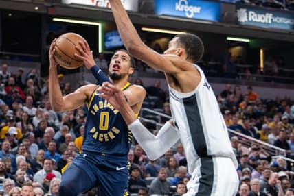 Nov 6, 2023; Indianapolis, Indiana, USA; Indiana Pacers guard Tyrese Haliburton (0)  shoots the ball while San Antonio Spurs center Victor Wembanyama (1) defends in the first half at Gainbridge Fieldhouse. Mandatory Credit: Trevor Ruszkowski-USA TODAY Sports