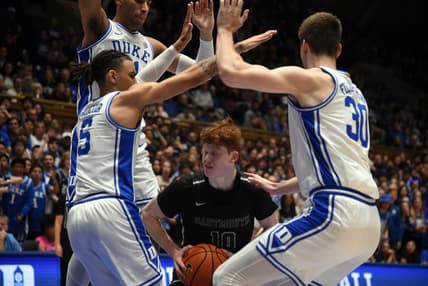 Nov 6, 2023; Durham, North Carolina, USA; Dartmouth Big Green guard Ryan Cornish (10) controls the ball as Duke Blue Devils center Kyle Filipowski(30) and guard Tyrese Proctor(5) defend during the first half at Cameron Indoor Stadium. Mandatory Credit: Rob Kinnan-USA TODAY Sports