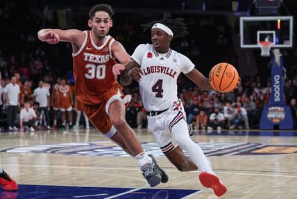 Nov 19, 2023; New York, New York, USA; Louisville Cardinals guard Ty-Laur Johnson (4) drives to the basket against Texas Longhorns forward Brock Cunningham (30) during the second half at Madison Square Garden. Mandatory Credit: Vincent Carchietta-USA TODAY Sports