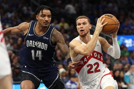 Nov 21, 2023; Orlando, Florida, USA;Toronto Raptors guard Malachi Flynn (22) drives to the basket as Orlando Magic guard Gary Harris (14) defends  during the second half at Amway Center. Mandatory Credit: Kim Klement Neitzel-USA TODAY Sports
