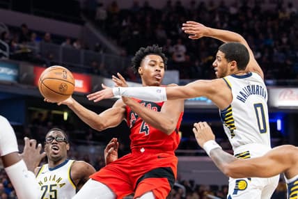 Nov 22, 2023; Indianapolis, Indiana, USA; Toronto Raptors forward Scottie Barnes (4) passes the ball while Indiana Pacers guard Tyrese Haliburton (0) defends in the first half at Gainbridge Fieldhouse. Mandatory Credit: Trevor Ruszkowski-USA TODAY Sports
