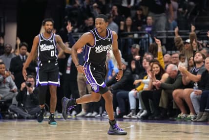 Dec 14, 2023; Sacramento, California, USA; Sacramento Kings guard De'Aaron Fox (5) reacts after making a three point basket against the Oklahoma City Thunder during the fourth quarter at Golden 1 Center. Mandatory Credit: Darren Yamashita-USA TODAY Sports