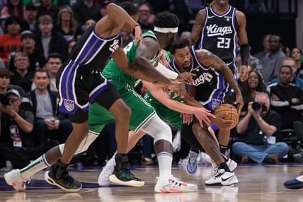 Dec 20, 2023; Sacramento, California, USA; Sacramento Kings guard Malik Monk (0) and Boston Celtics guard Payton Pritchard (11) fight for possession of the ball during the first quarter at Golden 1 Center. Mandatory Credit: Ed Szczepanski-USA TODAY Sports