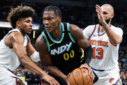 Dec 30, 2023; Indianapolis, Indiana, USA; Indiana Pacers guard Bennedict Mathurin (00) moves to shoot the ball whileNew York Knicks guard Miles McBride (2) and guard Evan Fournier (13)  defend in the second quarter at Gainbridge Fieldhouse. Mandatory Credit: Trevor Ruszkowski-USA TODAY Sports
