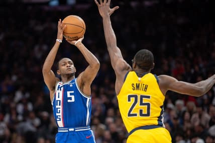 Jan 18, 2024; Sacramento, California, USA; Sacramento Kings guard De'Aaron Fox (5) takes a three point shot against Indiana Pacers forward Jalen Smith (25) during the second quarter at Golden 1 Center. Mandatory Credit: Ed Szczepanski-USA TODAY Sports