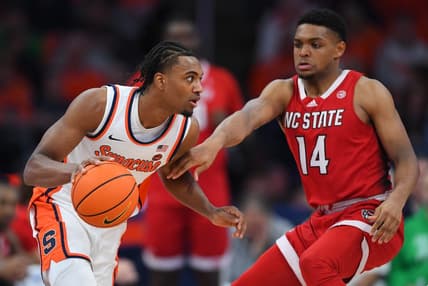 Jan 27, 2024; Syracuse, New York, USA; Syracuse Orange guard JJ Starling (2) drives to the basket as North Carolina State Wolfpack guard Casey Morsell (14) defends during the first half at the JMA Wireless Dome. Mandatory Credit: Rich Barnes-USA TODAY Sports