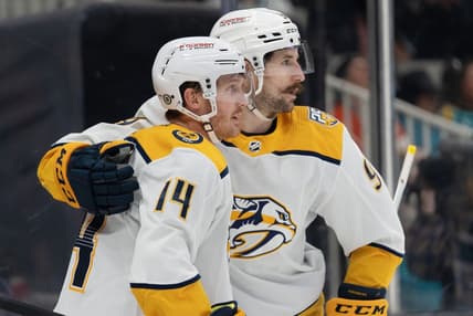 Feb 24, 2024; San Jose, California, USA; Nashville Predators left wing Filip Forsberg (9) hugs center Gustav Nyquist (14) after scoring a goal during the third period against the San Jose Sharks at SAP Center at San Jose. Mandatory Credit: Stan Szeto-USA TODAY Sports