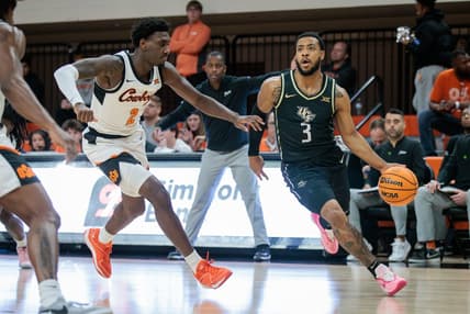 Feb 28, 2024; Stillwater, Oklahoma, USA; UCF Knights guard Darius Johnson (3) drives to the basket around Oklahoma State Cowboys forward Eric Dailey Jr. (2) during the first half at Gallagher-Iba Arena. Mandatory Credit: William Purnell-USA TODAY Sports