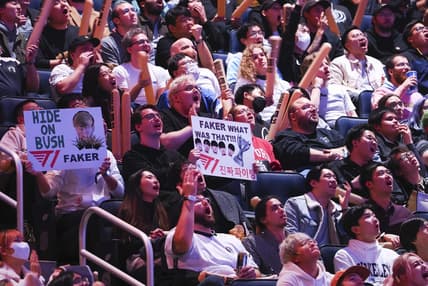 Nov 5, 2022; San Francisco, California, USA; Fans hold signs for T1 mid laner Lee "Faker" Sang-hyeok (not pictured) during the League of Legends World Championships against DRX at Chase Center. Mandatory Credit: Kelley L Cox-USA TODAY Sports
