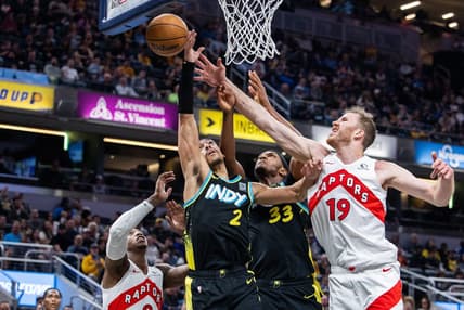 Feb 26, 2024; Indianapolis, Indiana, USA; Indiana Pacers guard Andrew Nembhard (2) shoots the ball while Toronto Raptors center Jakob Poeltl (19) defends in the second half at Gainbridge Fieldhouse. Mandatory Credit: Trevor Ruszkowski-USA TODAY Sports
