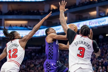Mar 4, 2024; Sacramento, California, USA; Sacramento Kings guard De'Aaron Fox (5) puts up a shot over Chicago Bulls center Andre Drummond (3) during the second quarter at Golden 1 Center. Mandatory Credit: Ed Szczepanski-USA TODAY Sports