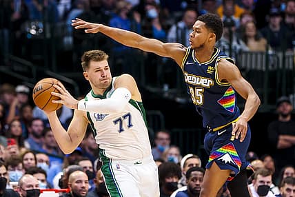 Nov 15, 2021; Dallas, Texas, USA; Dallas Mavericks guard Luka Doncic (77) looks to pass as Denver Nuggets guard P.J. Dozier (35) defends during the second half at American Airlines Center. Mandatory Credit: Kevin Jairaj-USA TODAY Sports