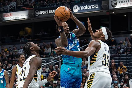 Dec 29, 2021; Indianapolis, Indiana, USA; Charlotte Hornets guard Terry Rozier (3) shoots against ndiana Pacers center Myles Turner (33) in the first quarter at Gainbridge Fieldhouse. Mandatory Credit: Trevor Ruszkowski-USA TODAY Sports