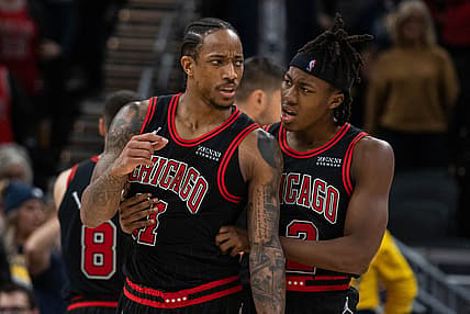 Dec 31, 2021; Indianapolis, Indiana, USA; Chicago Bulls forward DeMar DeRozan (11) is held back by Chicago Bulls guard Ayo Dosunmu (12) in the second half against the Indiana Pacers at Gainbridge Fieldhouse. Mandatory Credit: Trevor Ruszkowski-USA TODAY Sports