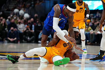 Jan 5, 2022; Denver, Colorado, USA; Utah Jazz guard Mike Conley (11) and Denver Nuggets forward Will Barton (5) play for the ball in the first quarter at Ball Arena. Mandatory Credit: Ron Chenoy-USA TODAY Sports