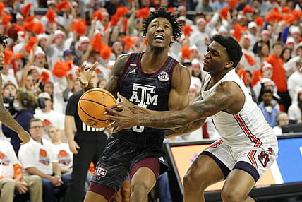 Feb 12, 2022; Auburn, Alabama, USA;  Texas A&M Aggies guard Quenton Jackson (3) is fouled by Auburn Tigers guard K.D. Johnson (0) during the first half at Auburn Arena. Mandatory Credit: John Reed-USA TODAY Sports