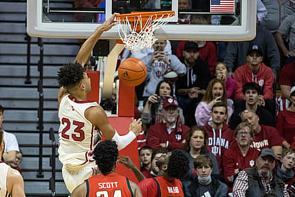 Feb 24, 2022; Bloomington, Indiana, USA; Indiana Hoosiers forward Trayce Jackson-Davis (23) slam dunks the ball while Maryland Terrapins forward Qudus Wahab (33) defends in the second half at Simon Skjodt Assembly Hall. Mandatory Credit: Trevor Ruszkowski-USA TODAY Sports