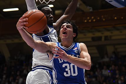 Oct 15, 2021; Durham, NC, USA;  Duke Blue Devils guard Michael Savarino (30) lays the ball up as center Mark Williams(15) defends during Duke Countdown to Craziness at Cameron Indoor Stadium. Mandatory Credit: Rob Kinnan-USA TODAY Sports