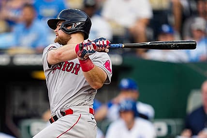Aug 6, 2022; Kansas City, Missouri, USA; Boston Red Sox first baseman Bobby Dalbec (29) hits a single against the Kansas City Royals during the second inning at Kauffman Stadium. Mandatory Credit: Jay Biggerstaff-USA TODAY Sports
