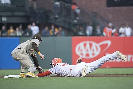 Aug 30, 2022; San Francisco, California, USA; San Diego Padres second baseman Jake Cronenworth (left) tags out San Francisco Giants center fielder Austin Slater (13) at second base during the first inning at Oracle Park. Mandatory Credit: Ed Szczepanski-USA TODAY Sports