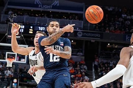 Mar 11, 2022; Indianapolis, IN, USA; Penn State Nittany Lions guard Sam Sessoms (12) passes the ball while Purdue Boilermakers forward Mason Gillis (0) defends  in the first half at Gainbridge Fieldhouse. Mandatory Credit: Trevor Ruszkowski-USA TODAY Sports