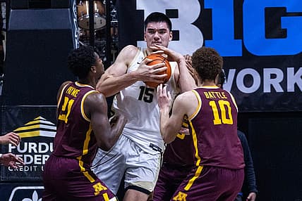 Dec 4, 2022; West Lafayette, Indiana, USA; Purdue Boilermakers center Zach Edey (15) rebounds the ball while Minnesota Golden Gophers forward Jamison Battle (10) and  guard Jackson Purcell (11) defend in the first half at Mackey Arena. Mandatory Credit: Trevor Ruszkowski-USA TODAY Sports