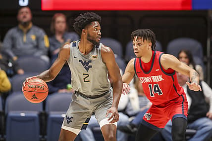 Dec 22, 2022; Morgantown, West Virginia, USA; West Virginia Mountaineers guard Kobe Johnson (2) dribbles against Stony Brook Seawolves guard Tyler Stephenson-Moore (14) during the first half at WVU Coliseum. Mandatory Credit: Ben Queen-USA TODAY Sports