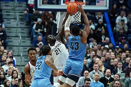 Dec 28, 2022; Hartford, Connecticut, USA; Connecticut Huskies forward Adama Sanogo (21) defends against Villanova Wildcats forward Eric Dixon (43) during the first half at XL Center. Mandatory Credit: David Butler II-USA TODAY Sports