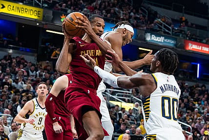 Feb 5, 2023; Indianapolis, Indiana, USA; Cleveland Cavaliers forward Evan Mobley (4) rebounds the ball while Indiana Pacers guard Bennedict Mathurin (00) defends in the second quarter at Gainbridge Fieldhouse. Mandatory Credit: Trevor Ruszkowski-USA TODAY Sports