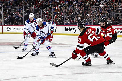 Nov 18, 2023; Newark, New Jersey, USA; New York Rangers left wing Artemi Panarin (10) skates with the puck against New Jersey Devils left wing Jesper Bratt (63) and New Jersey Devils center Michael McLeod (20) during the first period at Prudential Center. Mandatory Credit: John Jones-USA TODAY Sports