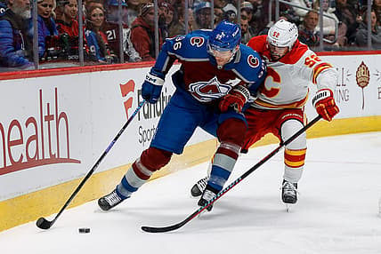 Nov 25, 2023; Denver, Colorado, USA; Colorado Avalanche right wing Mikko Rantanen (96) and Calgary Flames defenseman MacKenzie Weegar (52) battle for the puck in the first period at Ball Arena. Mandatory Credit: Isaiah J. Downing-USA TODAY Sports