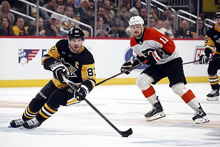 Dec 2, 2023; Pittsburgh, Pennsylvania, USA; Pittsburgh Penguins center Sidney Crosby (87) skates up ice with the puck ahead of Philadelphia Flyers right wing Travis Konecny (11) during the third period at PPG Paints Arena. The Flyers won 4-3 in a shootout. Mandatory Credit: Charles LeClaire-USA TODAY Sports