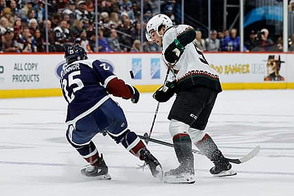 Dec 23, 2023; Denver, Colorado, USA; Colorado Avalanche right wing Logan O'Connor (25) and Arizona Coyotes defenseman Sean Durzi (50) battle for the puck in the third period at Ball Arena. Mandatory Credit: Isaiah J. Downing-USA TODAY Sports
