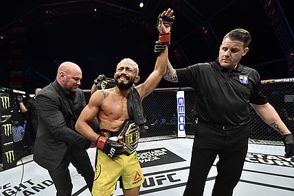 July 19, 2020; Abu Dhabi, UAE; Deiveson Figueiredo of Brazil celebrates after defeating Joseph Benavidez in their UFC flyweight championship bout during UFC Fight Night at the Flash Forum on UFC Fight Island. Mandatory Credit: Jeff Bottari/Zuffa LLC via USA TODAY Sports