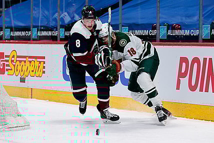 Feb 2, 2021; Denver, Colorado, USA; Colorado Avalanche defenseman Cale Makar (8) and Minnesota Wild left wing Jordan Greenway (18) battle for the puck in the third period at Ball Arena. Mandatory Credit: Isaiah J. Downing-USA TODAY Sports