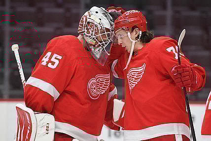 Mar 11, 2021; Detroit, Michigan, USA; Detroit Red Wings goaltender Jonathan Bernier (45) and defenseman Troy Stecher (70) celebrate after the game against the Tampa Bay Lightning at Little Caesars Arena. Mandatory Credit: Tim Fuller-USA TODAY Sports
