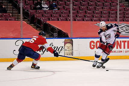 Apr 4, 2021; Sunrise, Florida, USA; Florida Panthers center Aleksander Barkov (16) reaches for the puck on Columbus Blue Jackets defenseman David Savard (58) during the first period at BB&T Center. Mandatory Credit: Jasen Vinlove-USA TODAY Sports