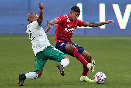 Apr 17, 2021; Frisco, Texas, USA; Colorado Rapids forward Michael Barrios (12) fights to control the ball against FC Dallas defender Jose Martinez (3) at Toyota Stadium. Mandatory Credit: Matthew Emmons-USA TODAY Sports