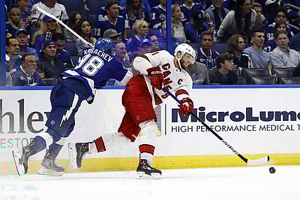 Jun 3, 2021; Tampa, Florida, USA; Carolina Hurricanes center Jordan Staal (11) passes the puck as Tampa Bay Lightning defenseman Mikhail Sergachev (98) defends during the second period in game three of the second round of the 2021 Stanley Cup Playoffs at Amalie Arena. Mandatory Credit: Kim Klement-USA TODAY Sports