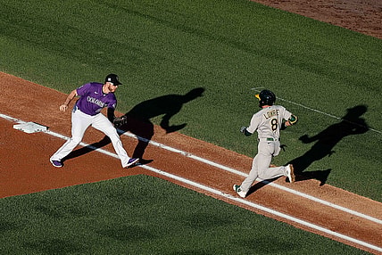 Jun 4, 2021; Denver, Colorado, USA; Oakland Athletics second baseman Jed Lowrie (8) runs towards the tag from Colorado Rockies first baseman C.J. Cron (25) in the first inning at Coors Field. Mandatory Credit: Isaiah J. Downing-USA TODAY Sports