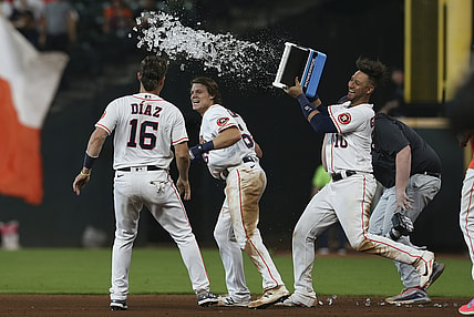 Aug 25, 2021; Houston, Texas, USA; Houston Astros left fielder Aledmys Diaz (16) and  first baseman Yuli Gurriel (10) celebrate center fielder Jake Meyers (6) game winning RBI single against the Kansas City Royals in the tenth inning at Minute Maid Park. Mandatory Credit: Thomas Shea-USA TODAY Sports