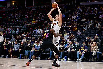 Nov 8, 2021; Denver, Colorado, USA; Denver Nuggets center Nikola Jokic (15) looks to pass the ball as Miami Heat forward Jimmy Butler (22) guards in the first quarter at Ball Arena. Mandatory Credit: Isaiah J. Downing-USA TODAY Sports