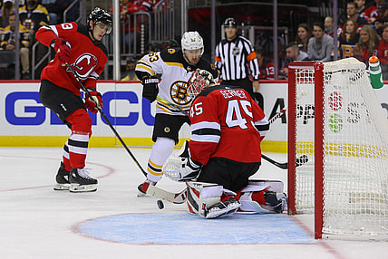 Nov 13, 2021; Newark, New Jersey, USA; New Jersey Devils goaltender Jonathan Bernier (45) makes a save while Boston Bruins center Brad Marchand (63) looks for the rebound during the first period at Prudential Center. Mandatory Credit: Ed Mulholland-USA TODAY Sports