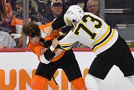 Nov 20, 2021; Philadelphia, Pennsylvania, USA; Philadelphia Flyers left wing Joel Farabee (86) fights with Boston Bruins defenseman Charlie McAvoy (73) during the second period at Wells Fargo Center. Mandatory Credit: Eric Hartline-USA TODAY Sports