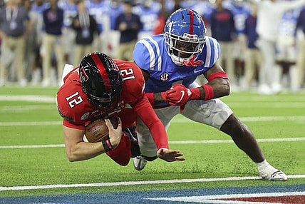 Dec 28, 2022; Houston, Texas, USA; Texas Tech Red Raiders quarterback Tyler Shough (12) falls into the end zone for a touchdown as Mississippi Rebels safety Isheem Young (1) /defends during the first quarter in the 2022 Texas Bowl at NRG Stadium. Mandatory Credit: Troy Taormina-USA TODAY Sports