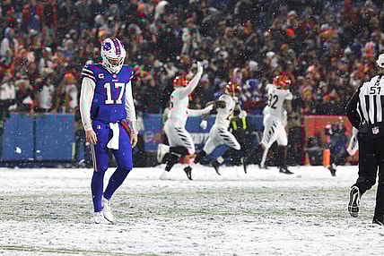 Bills quarterback Josh Allen walks off the field after throwing an interception late in the fourth quarter at Highmark Stadium in Orchard Park on Jan. 22  In the background the Cincinnati Bengals players celebrate.

Ty 012223 Dejected Josh Allen After Fourth Quarter Interception