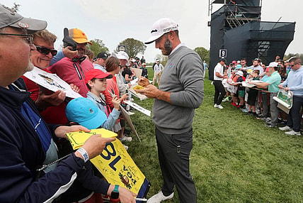LIV Golf star Dustin Johnson stops to sign autographs after a practice round at the PGA Championship on Tuesday, May 16, 2023.