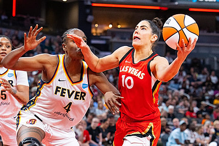 Jun 4, 2023; Indianapolis, Indiana, USA; Las Vegas Aces guard Kelsey Plum (10) shoots the ball while Indiana Fever center Queen Egbo (4) defends in the second half at Gainbridge Fieldhouse. Mandatory Credit: Trevor Ruszkowski-USA TODAY Sports