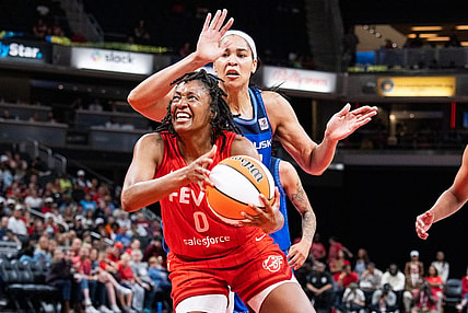 May 19, 2023; Indianapolis, Indiana, USA; Indiana Fever guard Kelsey Mitchell (0) shoots the ball while Connecticut Sun center Brionna Jones (42) defends in the second half at Gainbridge Fieldhouse. Mandatory Credit: Trevor Ruszkowski-USA TODAY Sports